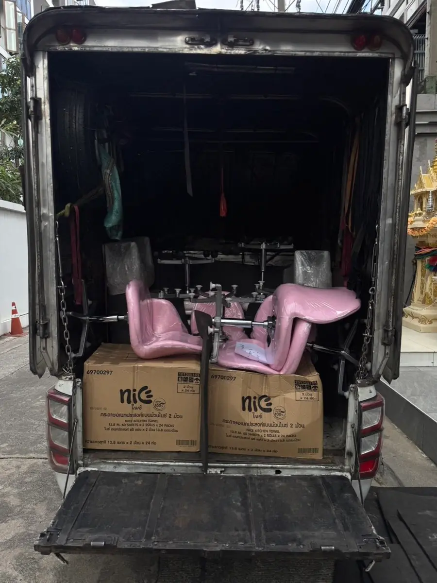 Pink salon chairs and boxes in the box truck