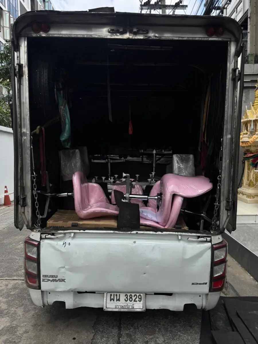 Pink chairs strapped in the box truck, ready to go