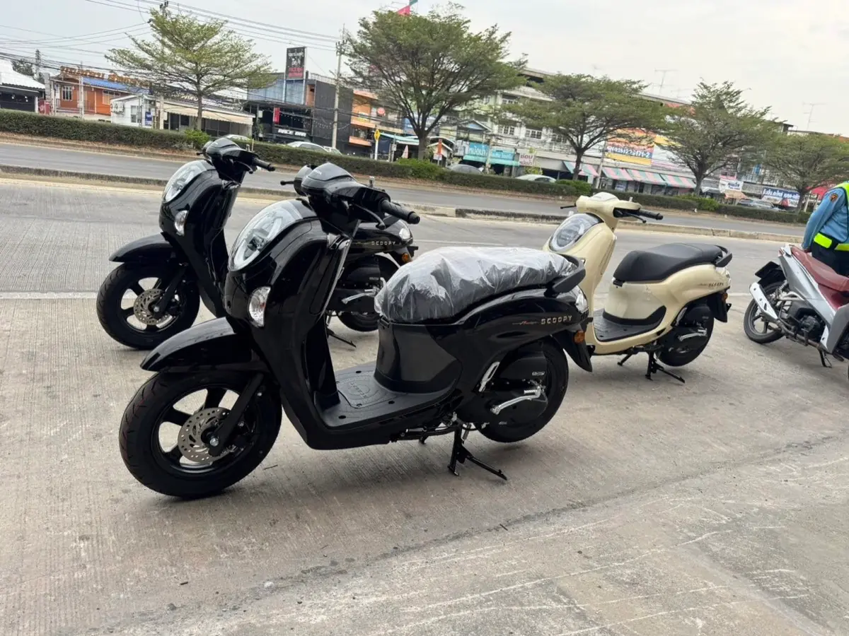 Black and cream scooters waiting outside the dealer