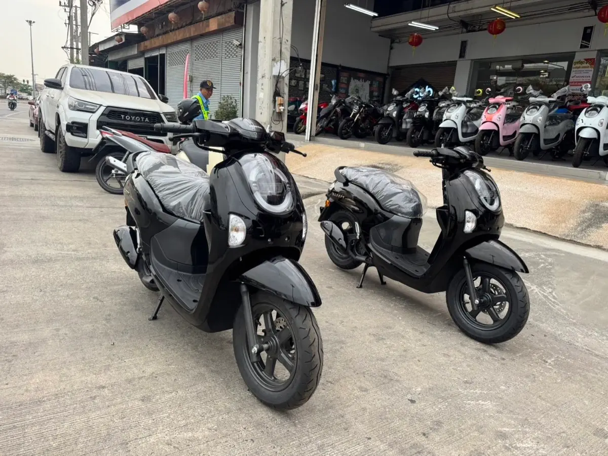 Two black scooters outside the dealer before transport